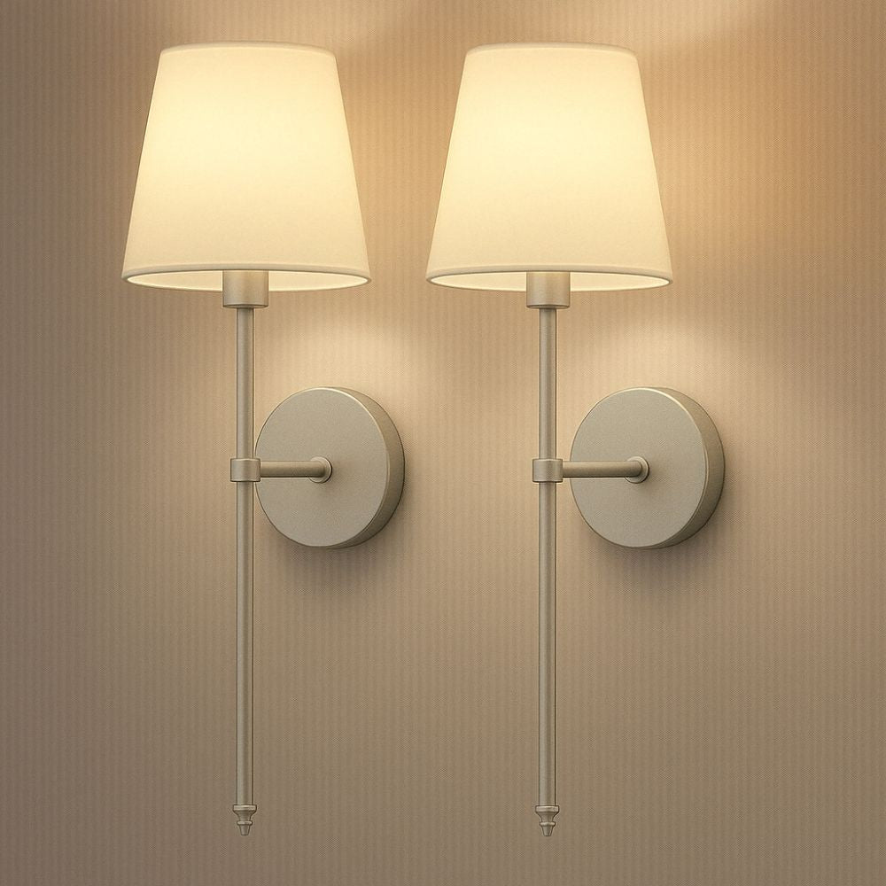 Two wall-mounted lamps with white shades on a beige wall.