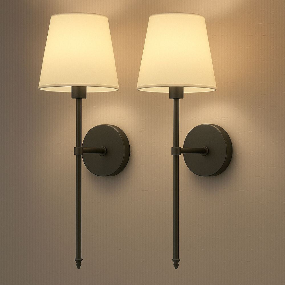 Two wall sconces with beige lampshades on a neutral wall.